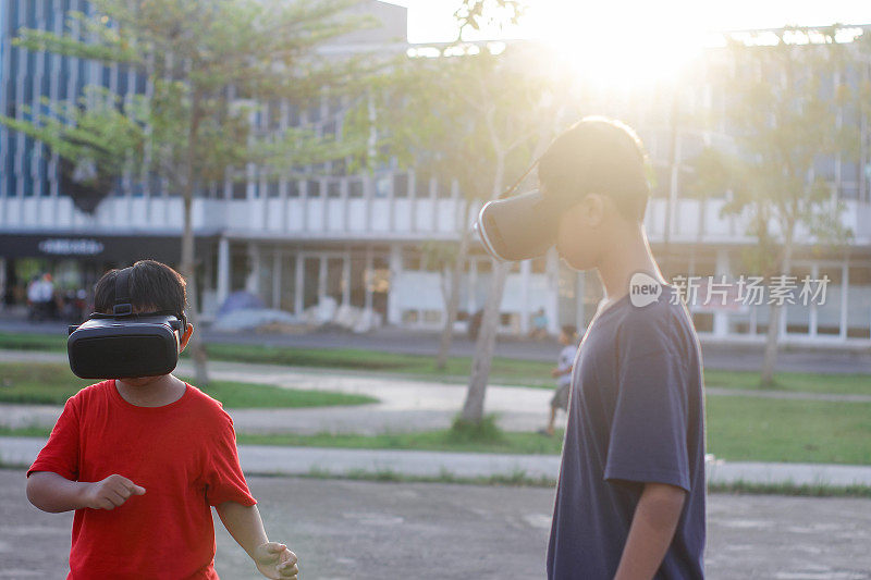 child with brother playing Virtual reality outdoor